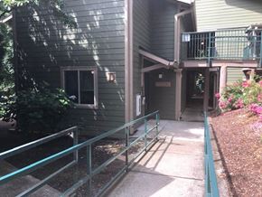 Sandy apartment for rent - a house with a porch and a walkway