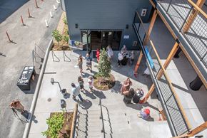 Portland apartment for rent - a group of people standing outside of a building
