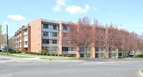 Spokane apartment for rent - A large brick building with a tree in front of it.