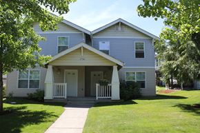 Forest Grove townhouse for rent - A two-story house with a front porch and a white door.
