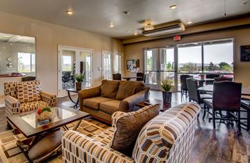 Cottonwood apartment for rent - A living room with a brown couch and a glass table.