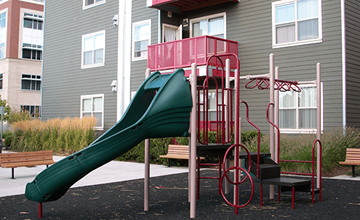 Portland apartment for rent - a playground with a slide in front of a building