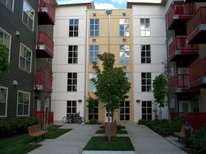 Portland apartment for rent - a view of the outside of an apartment building with a sidewalk and a bike