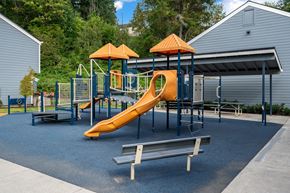 Clatskanie apartment for rent - a playground with a slide and benches in front of a building