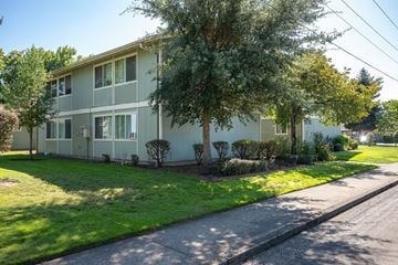 Albany apartment for rent - A tree in front of a two-story building.