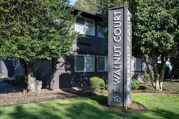 Corvallis apartment for rent - A sign for Walnut Court stands in front of a building.