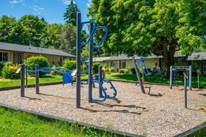 Vancouver apartment for rent - A playground with a blue swing set and a gravel ground.