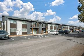 Redmond apartment for rent - A parking lot with a building in the background.