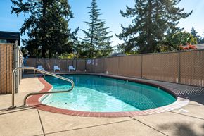 Portland apartment for rent - a resort style pool with a fence around it