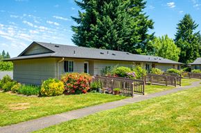 Vancouver apartment for rent - A house with a grey roof and a green lawn in front.