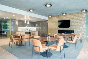 Portland apartment for rent - A modern dining room with a fireplace and a television.