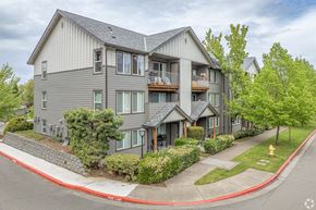 Hilsboro apartment for rent - A grey building with a red curb in front of it.