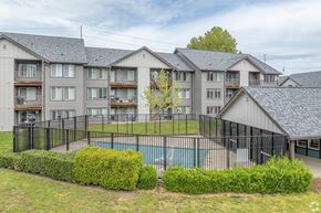 Hilsboro apartment for rent - A large apartment complex with a pool in the foreground.