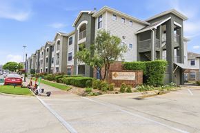 Austin apartment for rent - A row of apartment buildings with a sign that says "Villages at Hillcrest".