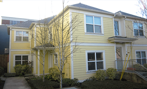 Portland apartment for rent - a yellow house with a sidewalk in front of it