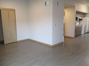 Molalla apartment for rent - an empty living room with wood floors and a kitchen