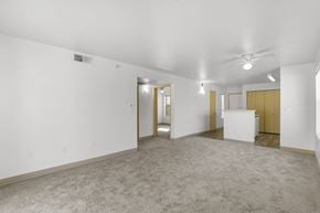 Rio Rancho apartment for rent - A spacious room with a carpeted floor and a ceiling fan.