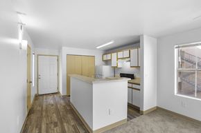 Rio Rancho apartment for rent - A kitchen with white cabinets and a wooden floor.
