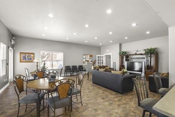 Rio Rancho apartment for rent - A spacious living room with a dining table and chairs.