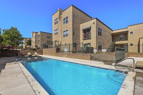 Rio Rancho apartment for rent - A swimming pool is located in front of a building.