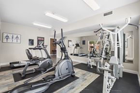 Los Ranchos De Albuquerque apartment for rent - A gym with a variety of equipment including treadmills, elliptical machines, and weight machines.