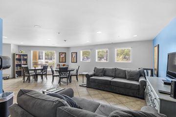 Albuquerque apartment for rent - A living room with grey couches and a dining table.
