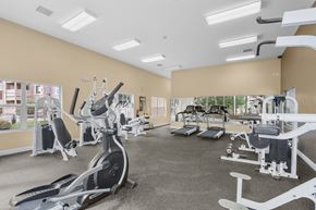 Albuquerque apartment for rent - A spacious gym with a variety of equipment including treadmills, stationary bikes, and weight machines.