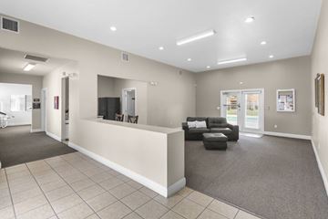 Albuquerque apartment for rent - A spacious living room with a grey carpet and a white sofa.