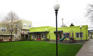 Portland apartment for rent - a playground in front of a green building