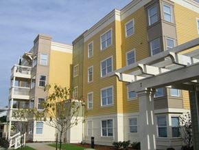 Portland apartment for rent - a row of yellow and white apartment buildings on a sunny day