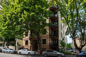 Portland apartment for rent - an apartment building with cars parked on the street