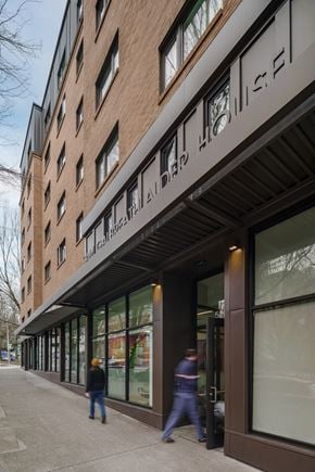 Portland apartment for rent - a large brick building with a black facade on the side of a road