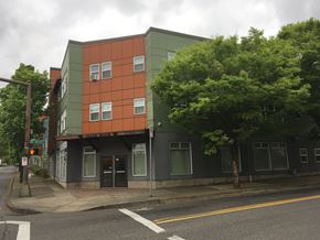 Portland apartment for rent - a green and orange building on the corner of a street