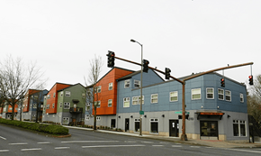 Portland apartment for rent - a row of buildings on a street corner at a traffic light