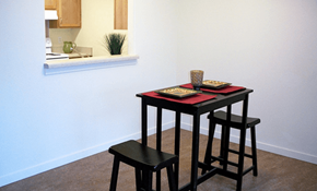 Portland apartment for rent - a small table and three stools in a room with a white wall