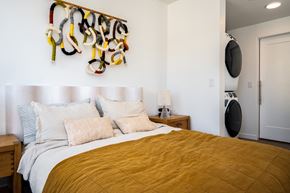 Portland apartment for rent - a bedroom with a bed and a wall with a rack of shoes on it at Slabtown Square Apartments, Portland , Oregon