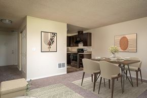 Vancouver apartment for rent - an open living room and dining room with a table and chairs