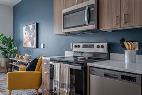 Milwaukie apartment for rent - a kitchen with a stove top oven next to a microwave oven