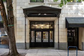 Portland apartment for rent - the entrance of a building with a black door and a tree