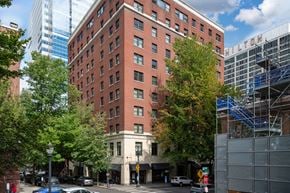 Portland apartment for rent - a tall red brick building on the corner of a city street