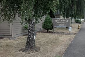 Lebanon apartment for rent - A sign for Park Manor Apartments is on a post in front of a tree.