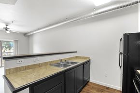 Albuquerque apartment for rent - A kitchen with black cabinets and a granite countertop.