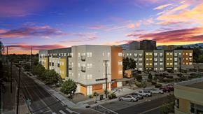 Albuquerque apartment for rent - A sunset view of a street with cars and buildings.