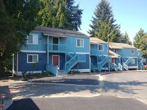Renton apartment for rent - A blue house with a red door and a balcony.