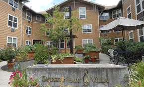 Portland apartment for rent - a retaining wall with plants in front of an apartment building