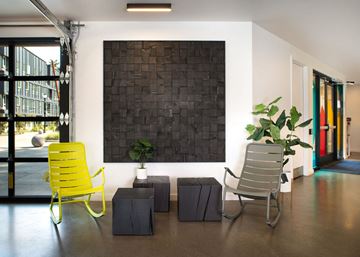 Portland apartment for rent - a living room with yellow chairs and a black wall