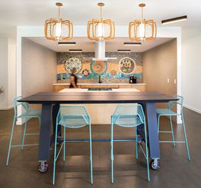 Portland apartment for rent - a large table with blue chairs in front of a mosaic wall