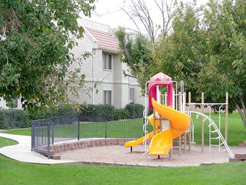 Bullhead apartment for rent - a playground with a slide in a park