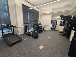 Portland apartment for rent - A gym with treadmills, elliptical machines, and a weight rack.