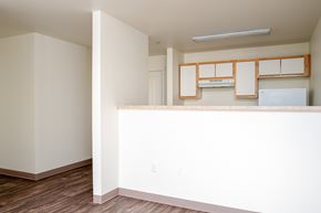 Gresham apartment for rent - A kitchen with white cabinets and a white fridge.